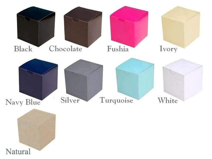 Colorful square gift boxes in various shades including black, pink, and ivory.