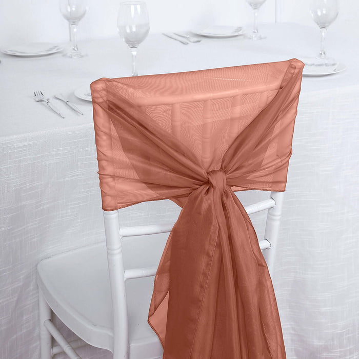 Peach chair sash tied on a white chair at a dining table.