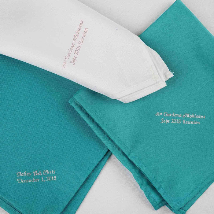 Embroidered napkins for family reunion, featuring names and dates.