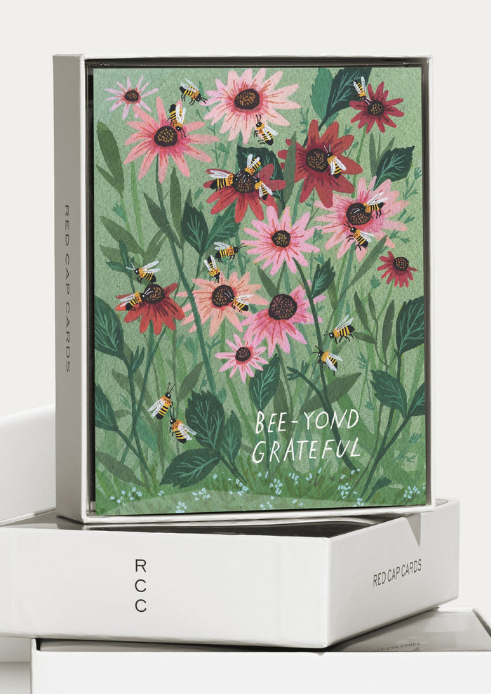 Card with floral design and 'Bee-yond Grateful' text on a white surface