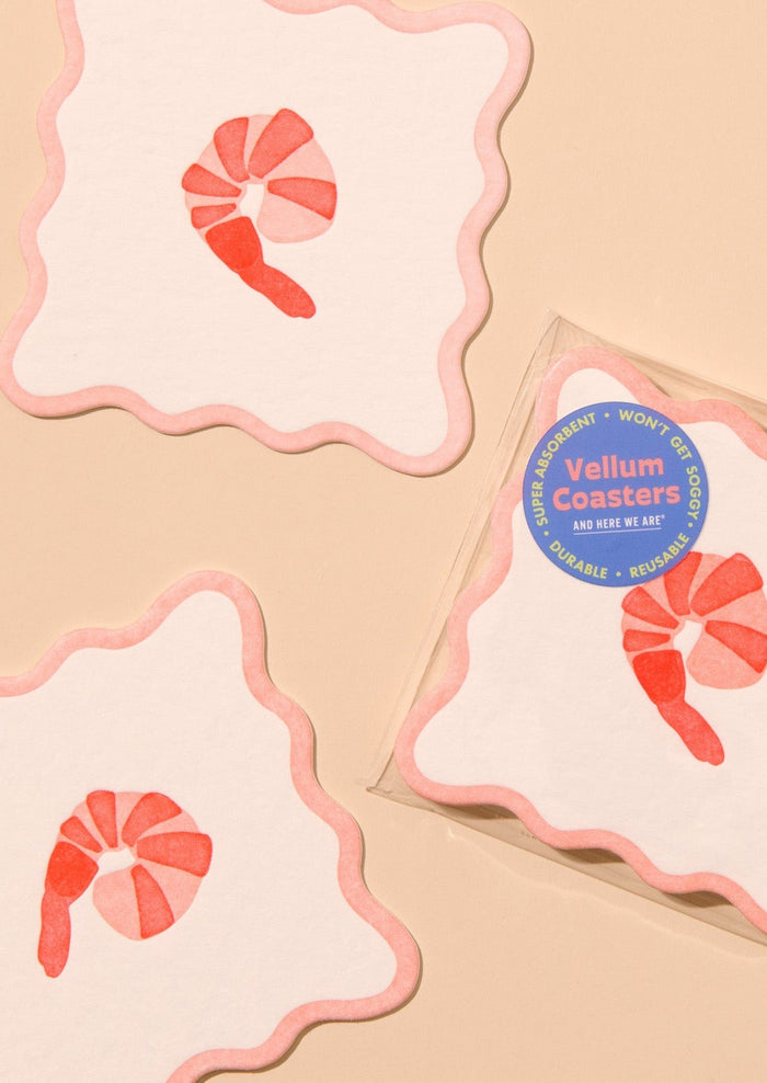 Decorative paper coasters with wavy edges and shrimp motif.