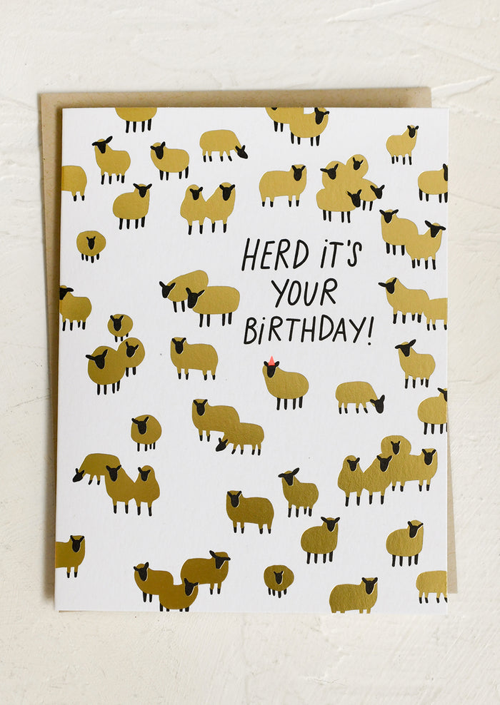 A greeting card picturing golden sheep, text reads "Herd it's your birthday".