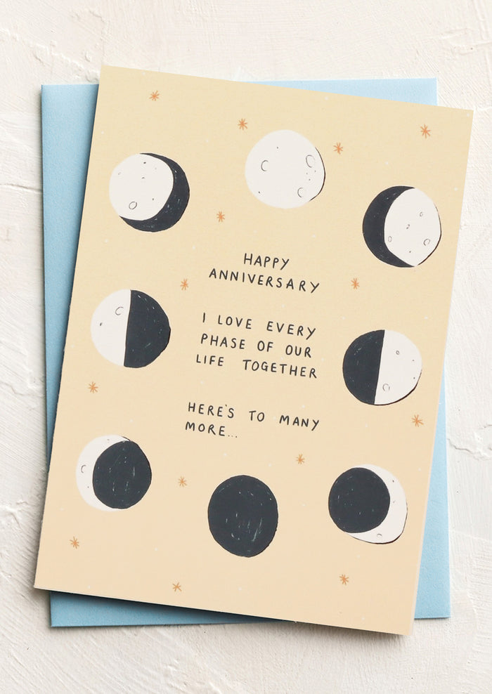 Greeting card with moon phases and anniversary message on a light background
