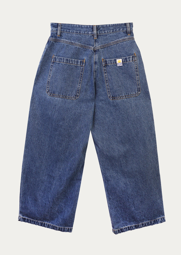 A pair of baggy pleat front jeans in medium blue wash.