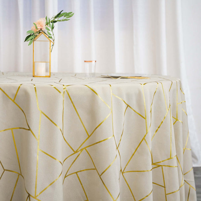 Gold geometric patterned tablecloth on a round table with decorative elements.
