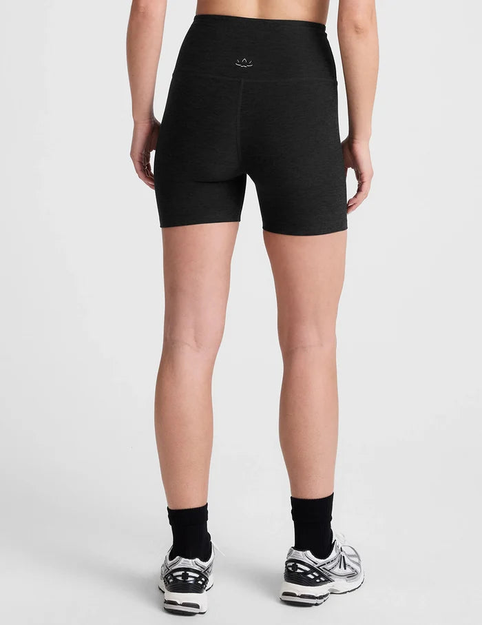Person wearing black athletic shorts on a white background