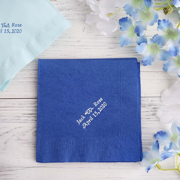 Personalized blue napkin with custom text for events, surrounded by flowers.