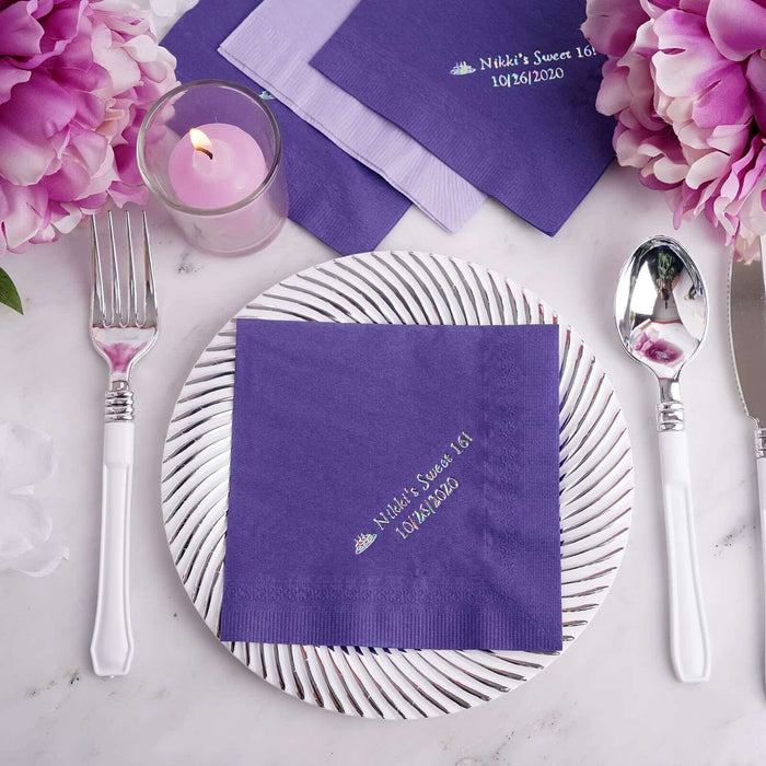 Personalized purple napkin for event celebration on a decorative plate.