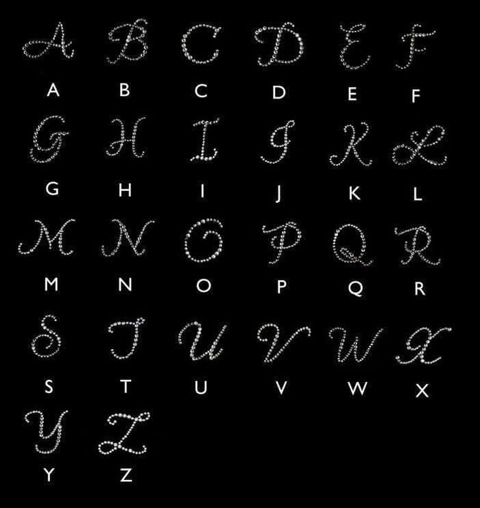Alphabet letters designed with sparkling rhinestones on a black background.