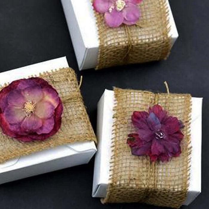Decorative gift boxes with dried flowers and burlap accents.