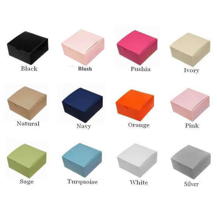 Colorful gift boxes in various shades including black, blush, fuchsia, and more.