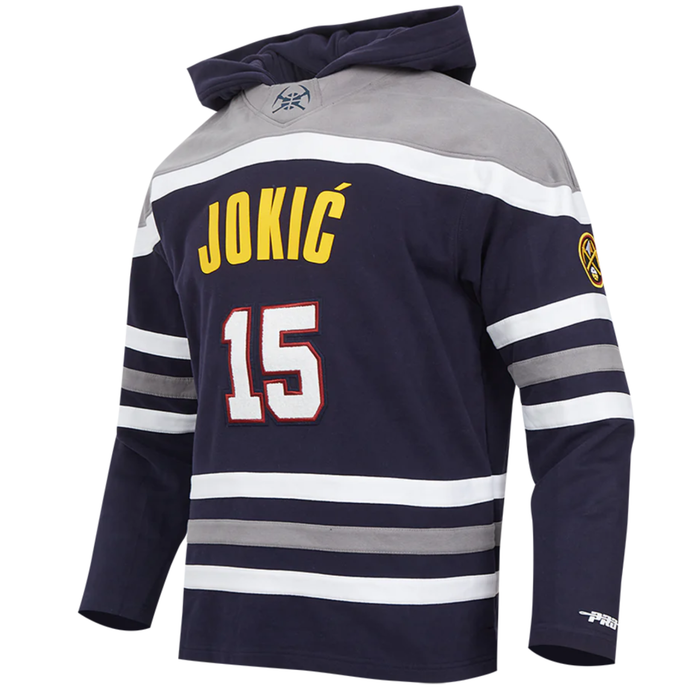Front left facing view Navy blue Denver Nuggets jersey-style hoody featuring 'JOKIC' and the number '15' in yellow and white on the back, with gray hood and white and gray stripes on the sleeves.