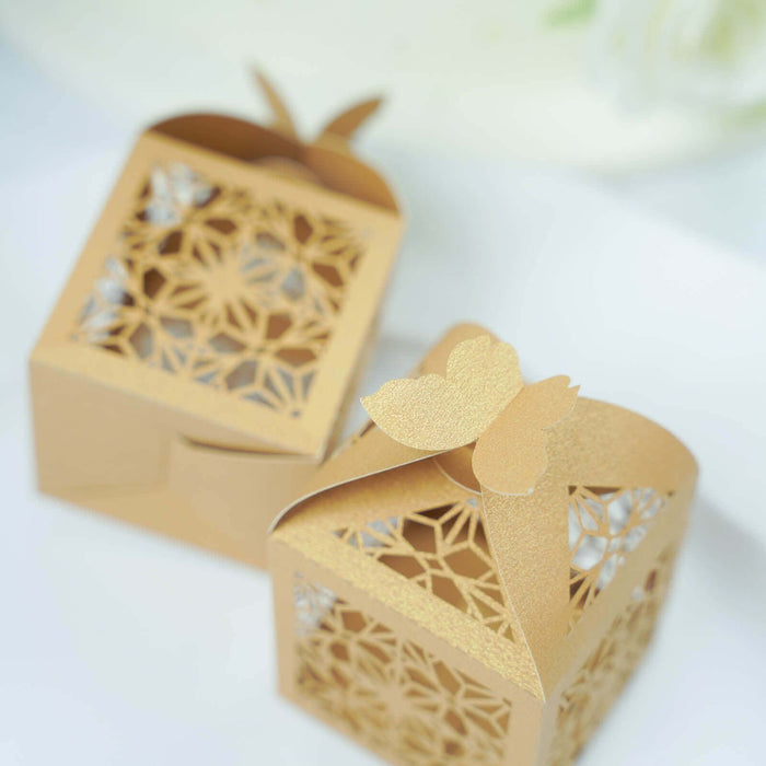 Gold decorative gift boxes with intricate cut-out designs and butterfly accents.