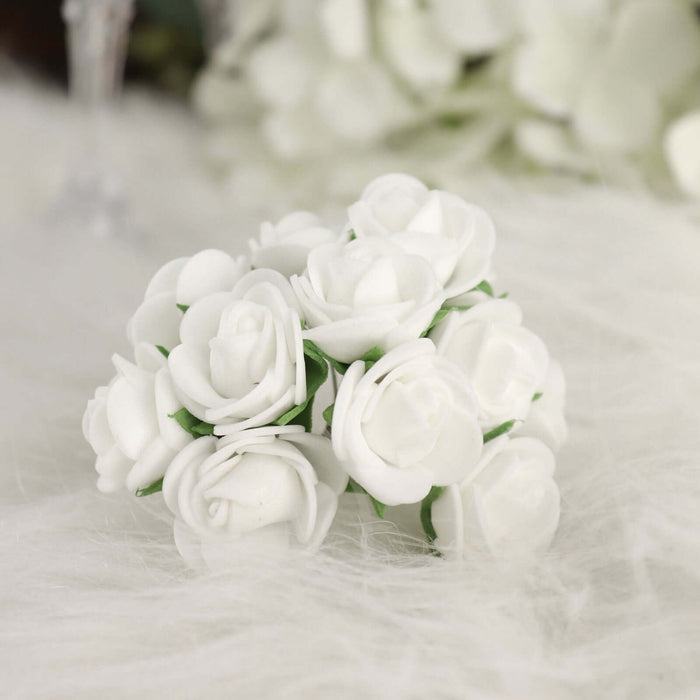 White artificial rose bouquet on soft white fabric.