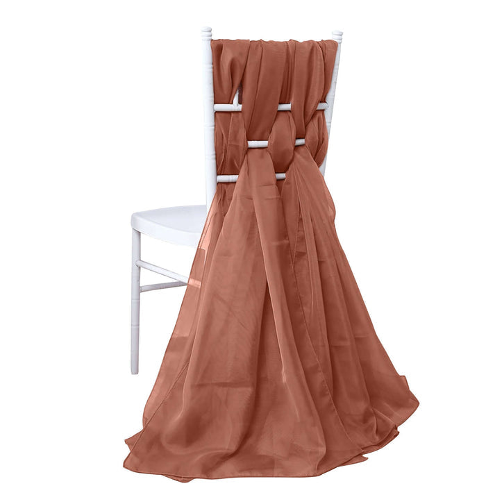Rust-colored sheer drape cascading from a white chair.