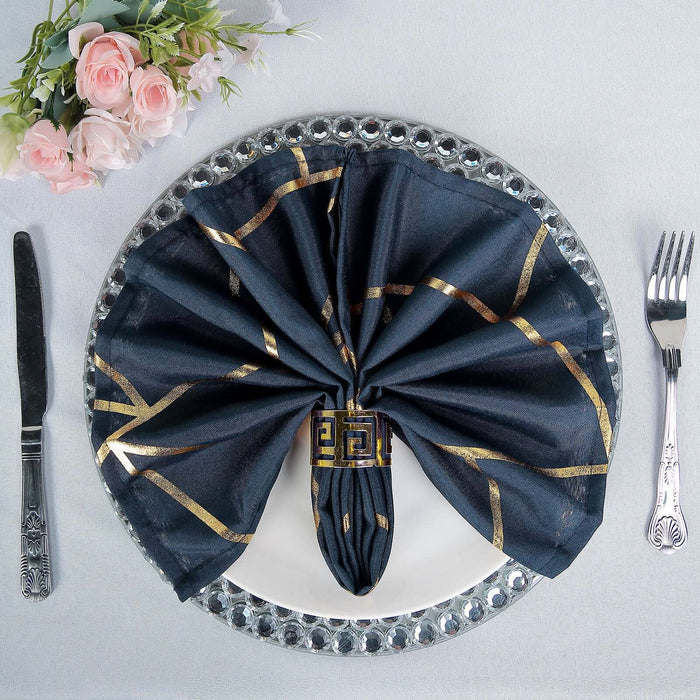 Elegant navy napkin with gold design, beautifully arranged on a plate.