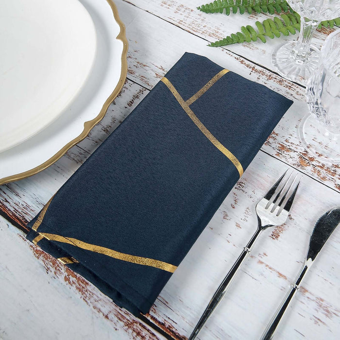 Navy blue napkin with gold stripes on a rustic table setting