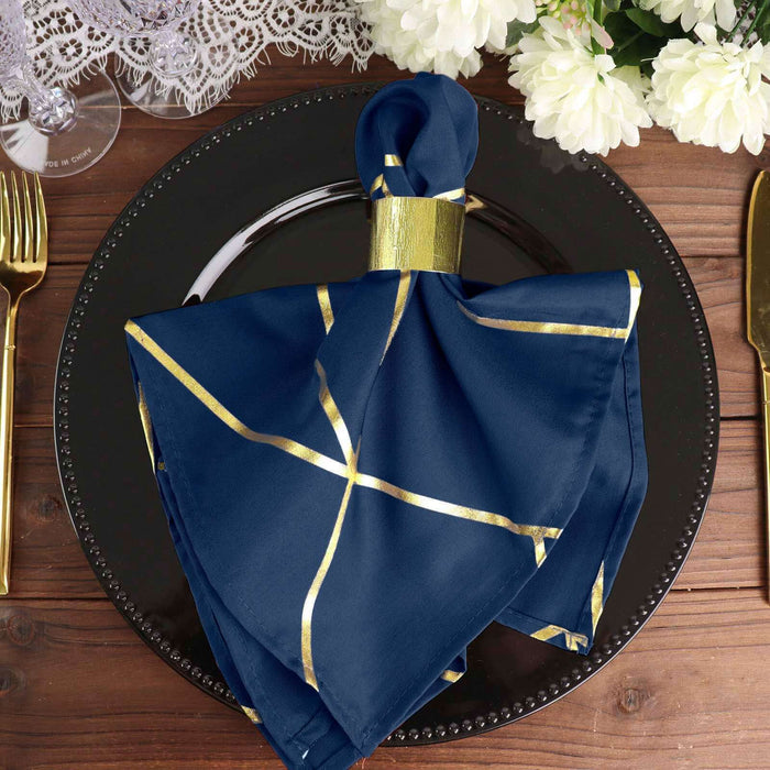 Elegant navy blue napkin with gold accents, styled on a black plate.