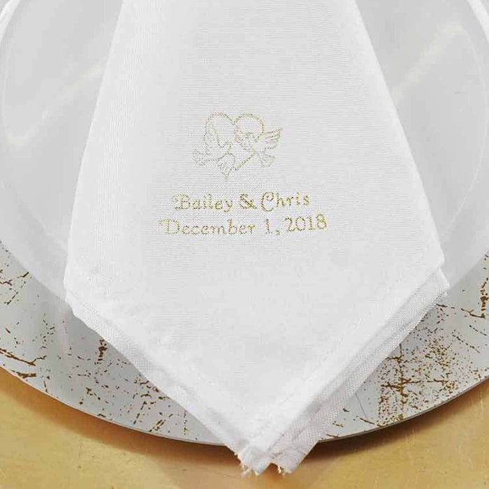 White embroidered wedding napkin with names and date on a decorative plate. #whtbkgd
