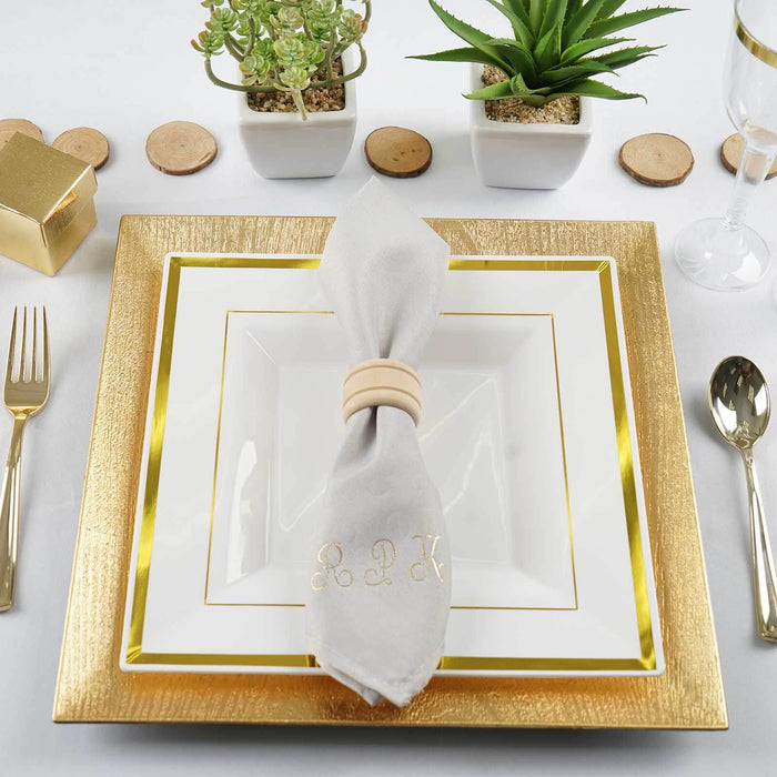 Elegant table setting with gold-accented plates and stylish napkin.