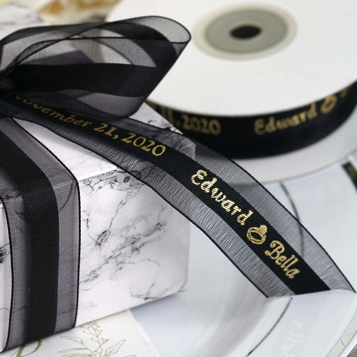 Personalized black ribbon for gift wrapping with gold lettering.