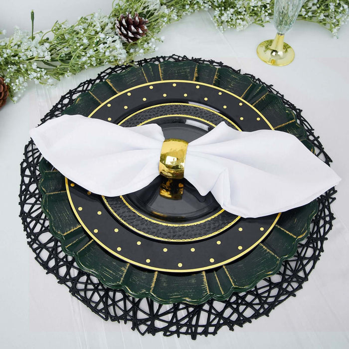 Elegant green and gold dinnerware set with a white napkin.