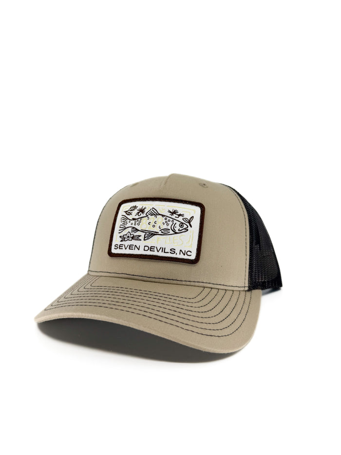 Khaki trucker hat with black mesh back and embroidered Seven Devils NC fish patch
