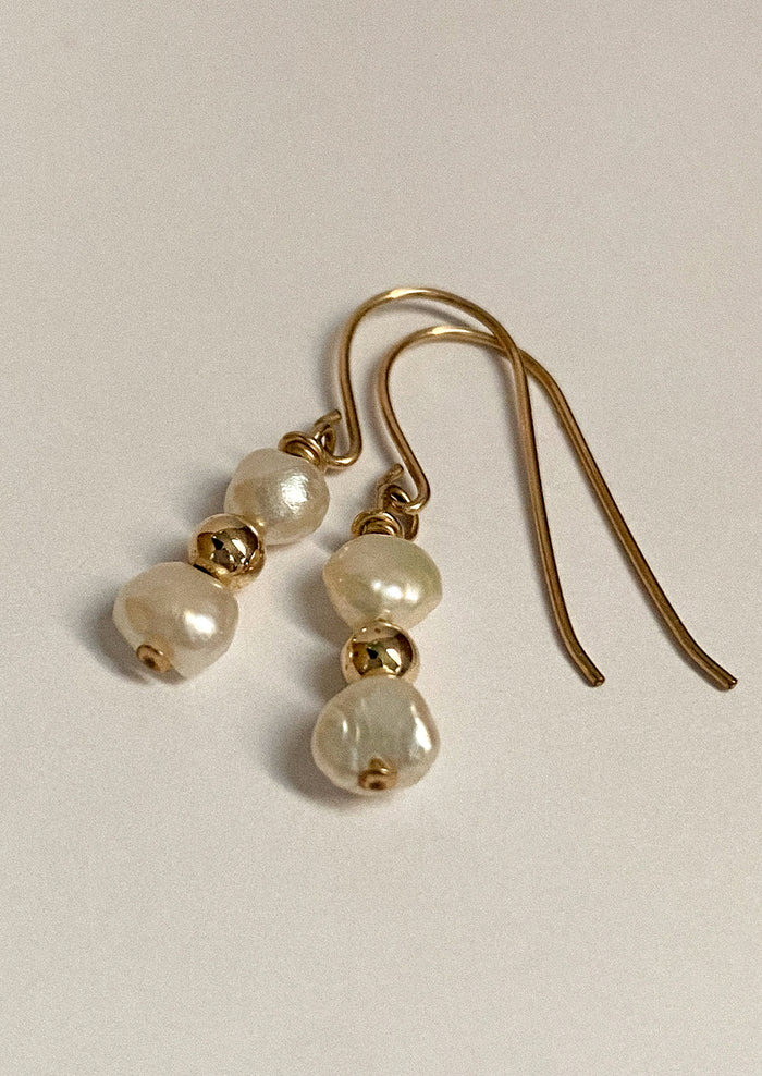 Pair of gold earrings with pearl beads.