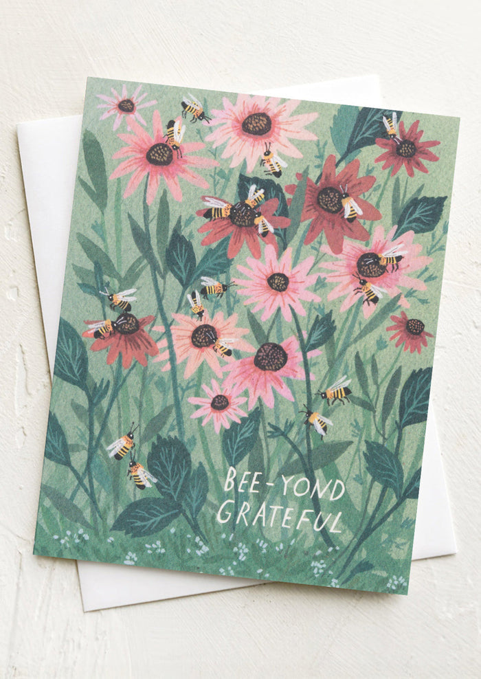 Card with pink flowers and bees design, featuring the text 'Bee-yond Grateful'.