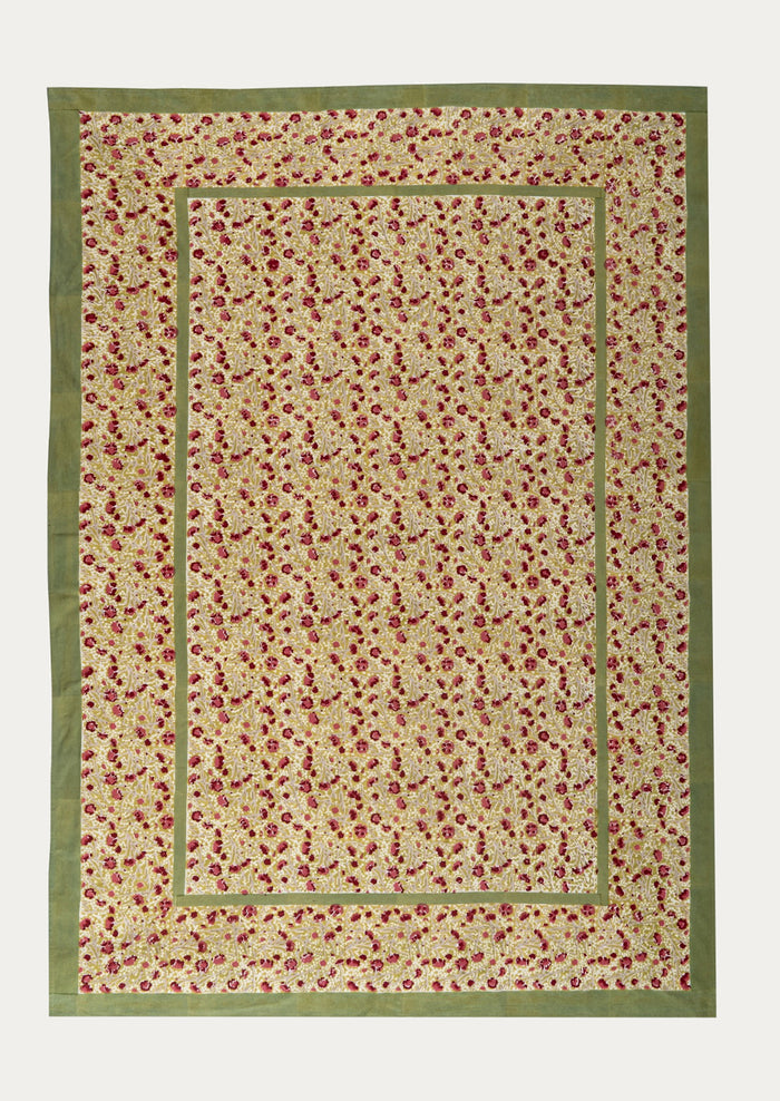 Floral patterned tablecloth with a green border on a white background