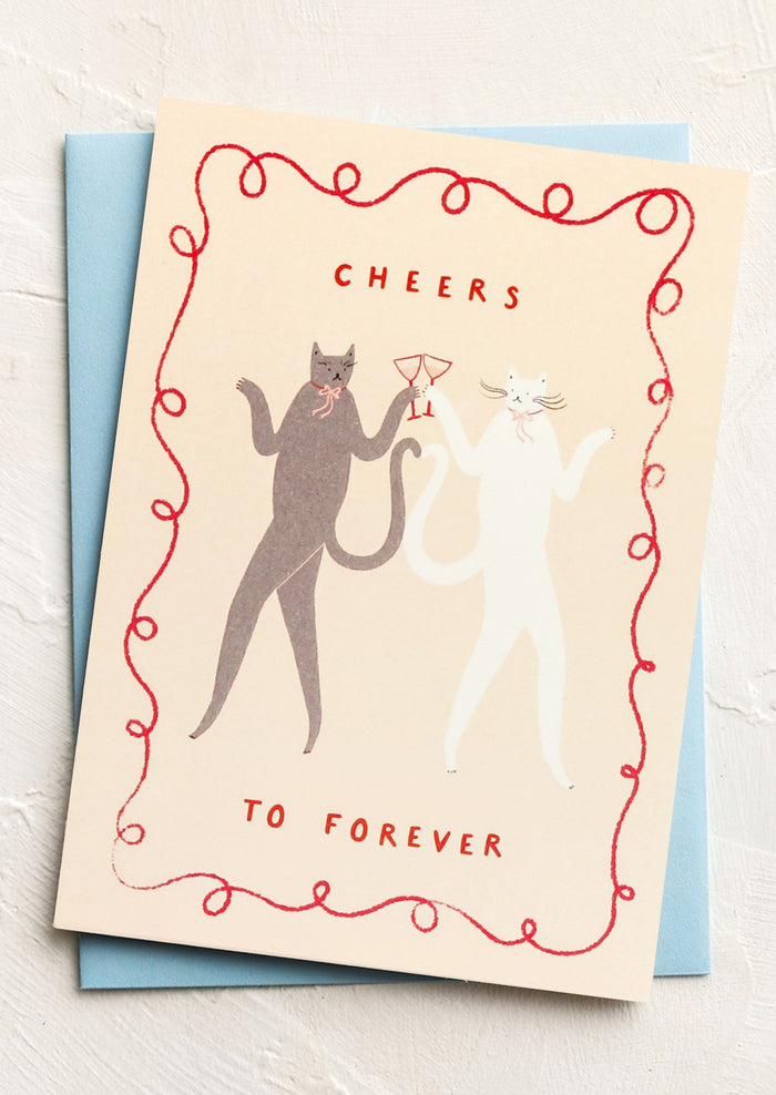 Greeting card with cats and 'Cheers to Forever' text on a light background