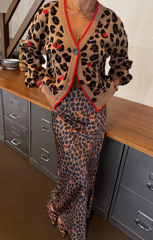 Person wearing a leopard print skirt  with a cardigan