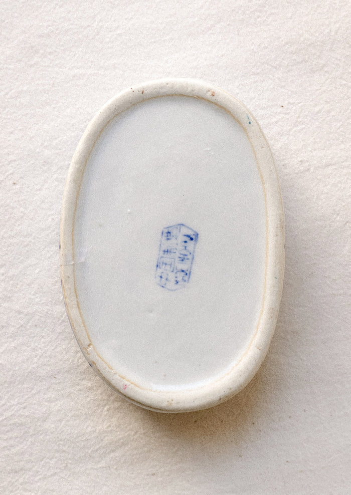 A blue and white chinoiserie patterned lidded ceramic box.