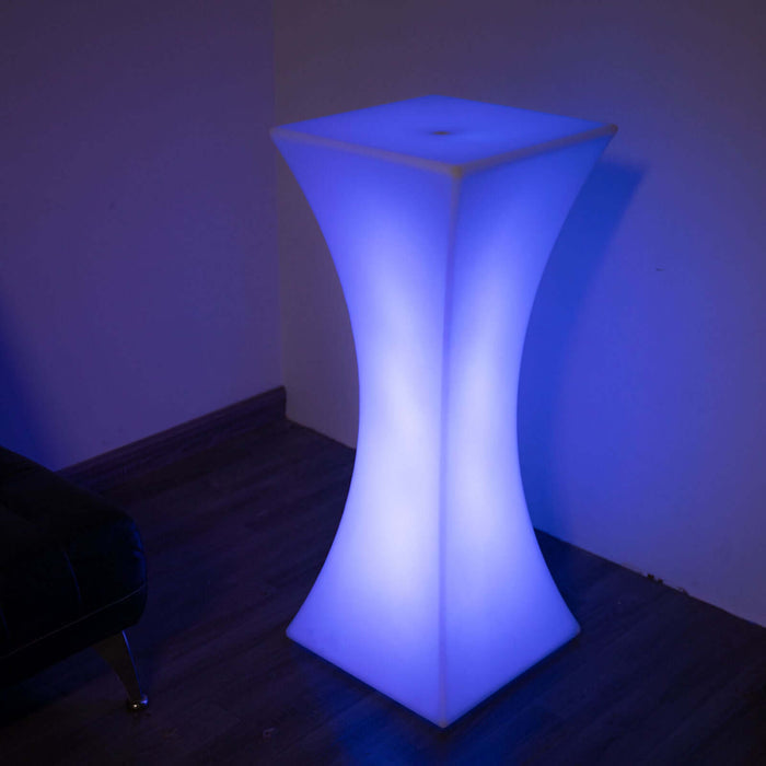 Modern illuminated bar table in blue glow, perfect for stylish events.