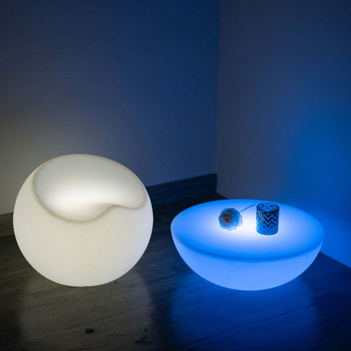 Modern illuminated table and decorative items in a stylish setting.