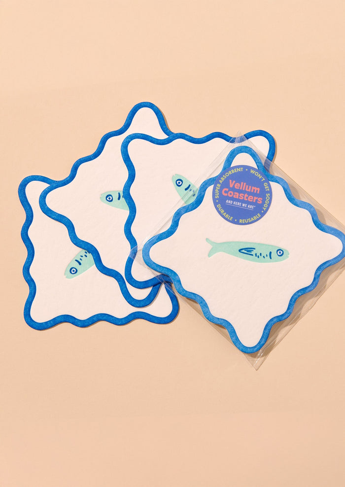 Decorative paper coasters with wavy edges and fish motif.