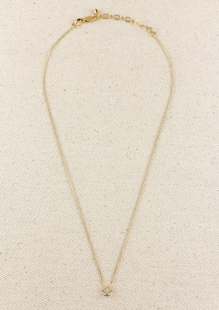 A gold box chain necklace with small gold & crystal star charm.