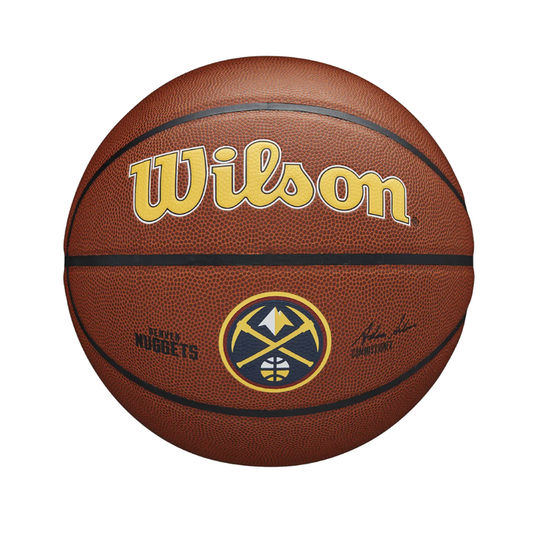 Front view of a brown leather-textured basketball featuring the Wilson logo in yellow with a dark outline. Below the logo is the circular Denver Nuggets primary team logo, accompanied by smaller secondary branding text to the left