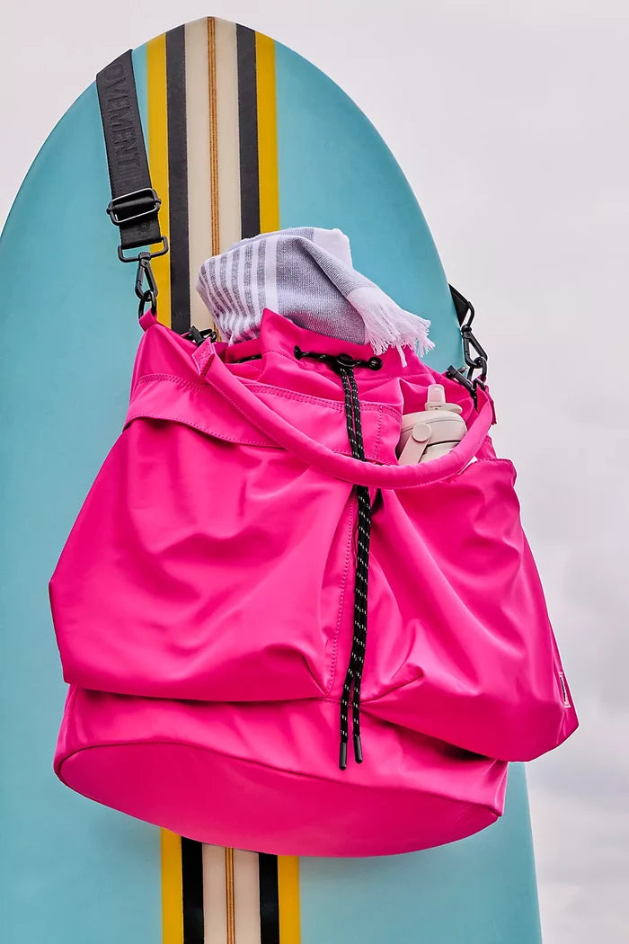 Free People Ego Boost Bucket Fuchsia Close Up hanging on surf board with towel and water bottle