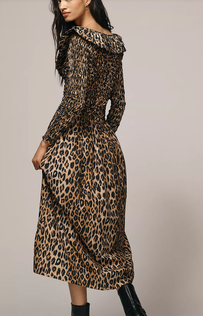 Leopard print dress worn by a model on a plain background