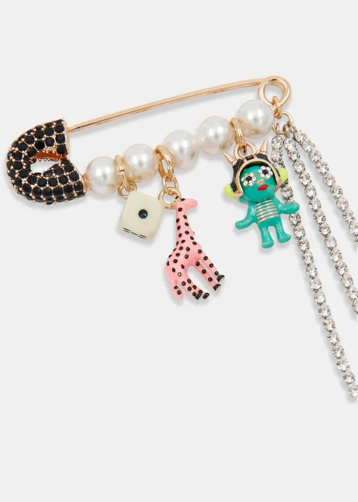 Safety Pin various charms including a black cat, pink dog, and green alien on a white background
