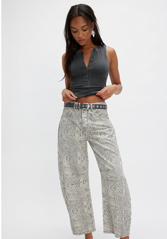 Woman wearing a black sleeveless top and wide-leg pants on a white background