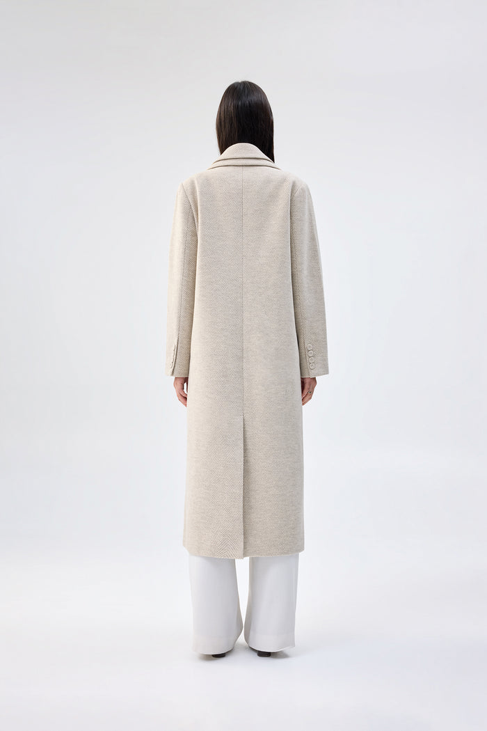 Beige textured faux wool coat with notch lapel, single-button closure, and full-length tailored fit, worn over white wide-leg trousers, back view
