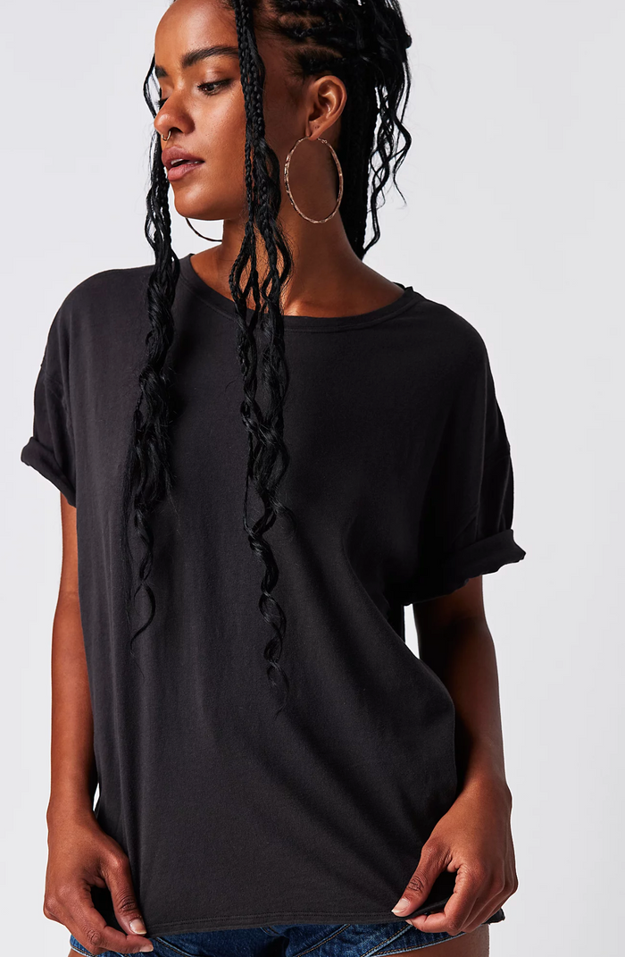 Woman wearing a black t-shirt against a white background
