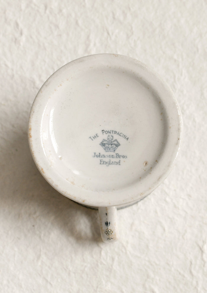 An antique English transferware mug with checkered lace pattern.