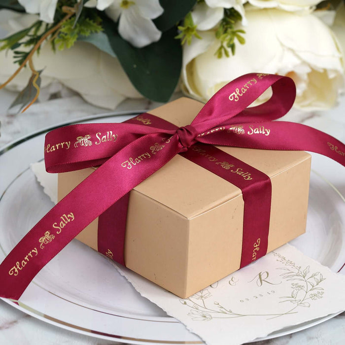 Gift box with burgundy ribbon and personalized label, elegantly presented on a plate.