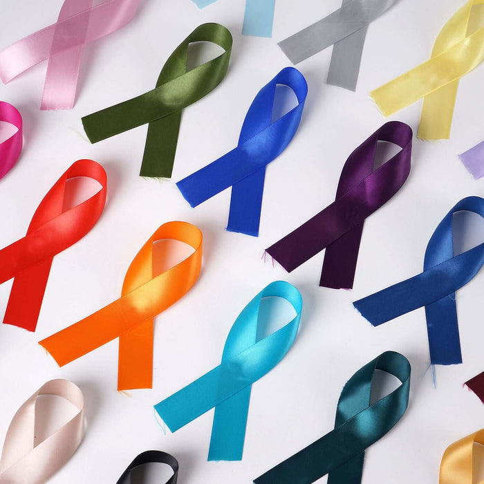 Colorful satin awareness ribbons arranged on a white background.