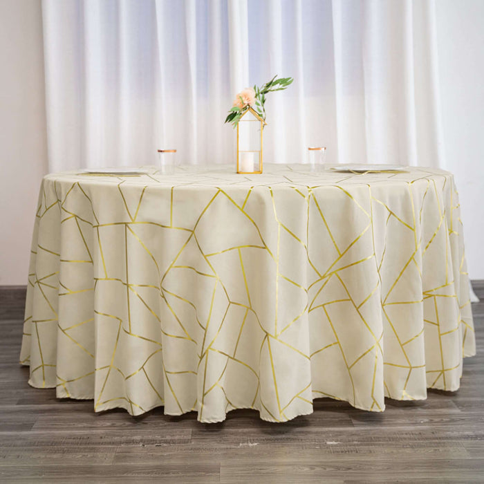 Elegant round table with a geometric patterned tablecloth in light cream and gold.
