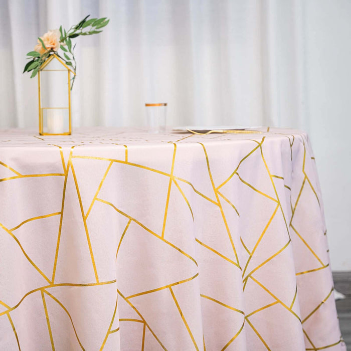 Pink tablecloth with gold geometric pattern on a dining table.