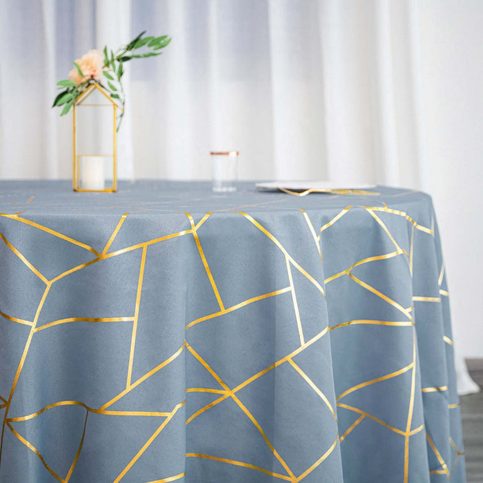 Blue tablecloth with gold geometric patterns draped over a round table.